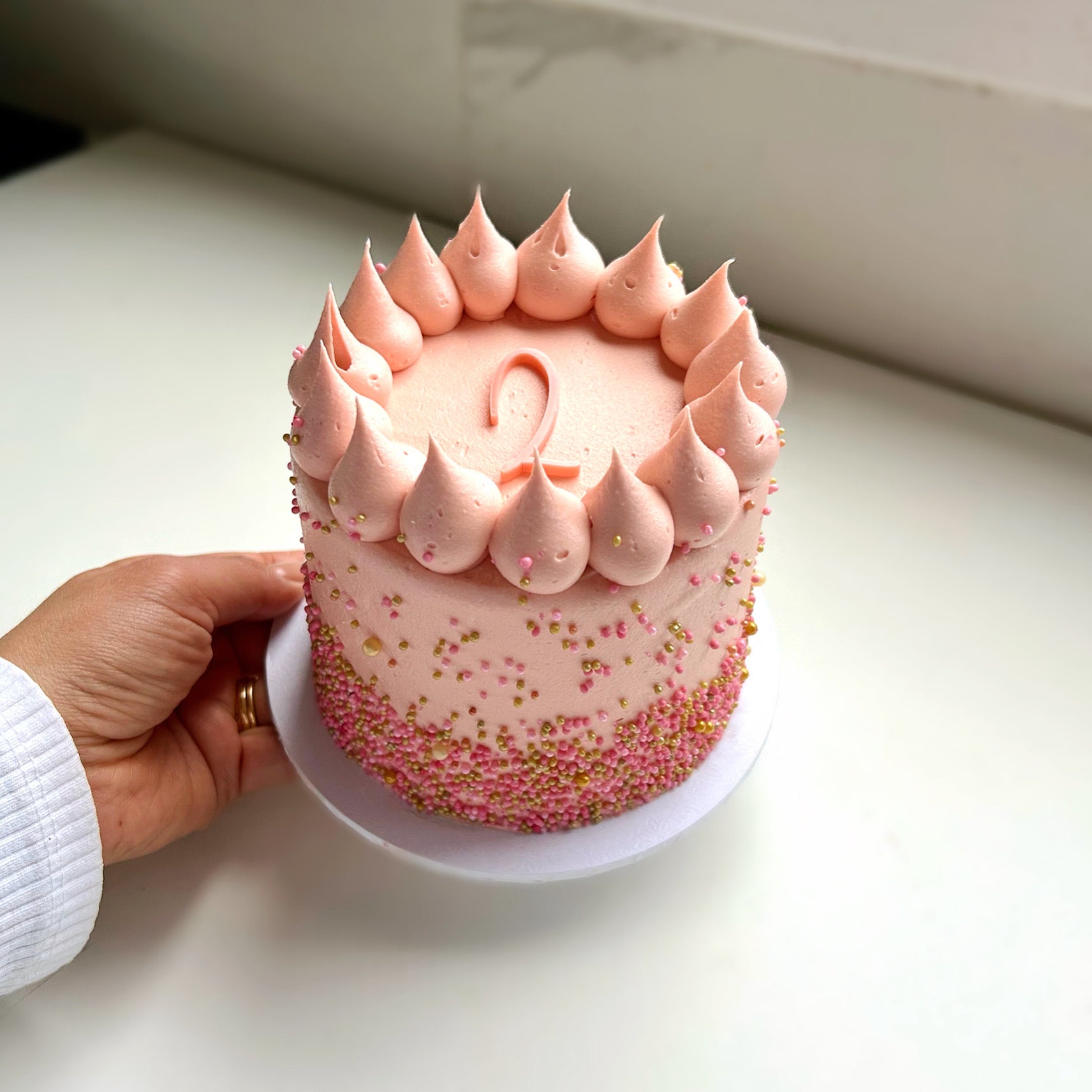 Pink sprinkle age cake 
